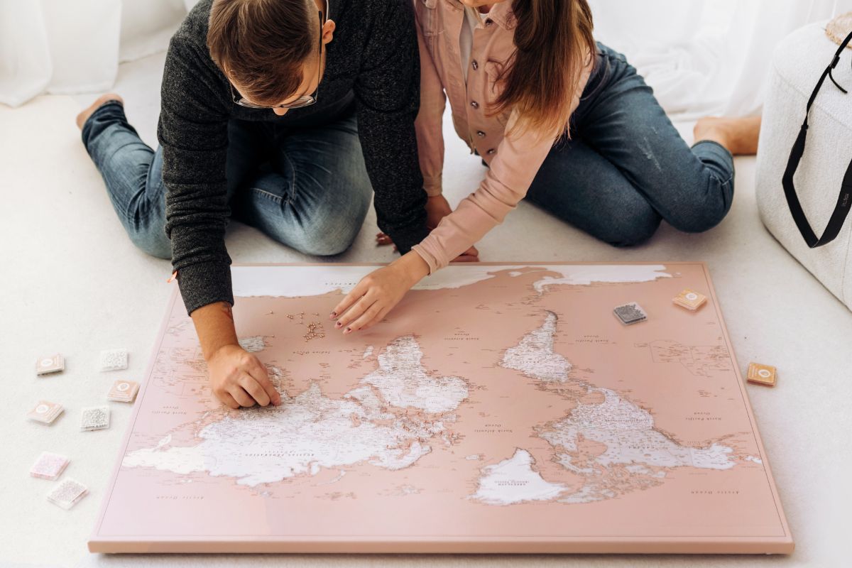 pink travel world map with pins